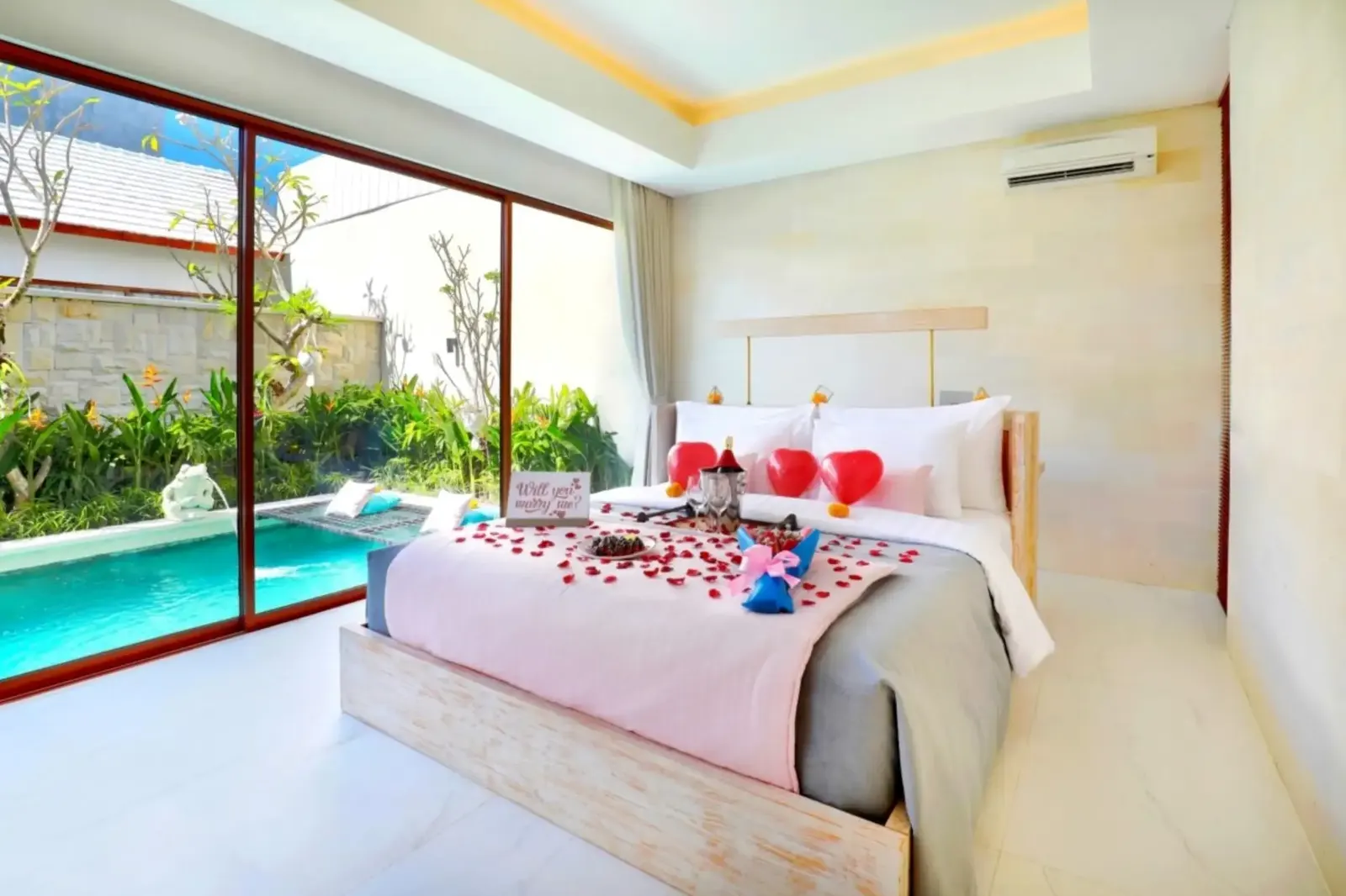 Romantic honeymoon bed decoration beside a private villa pool in Bali